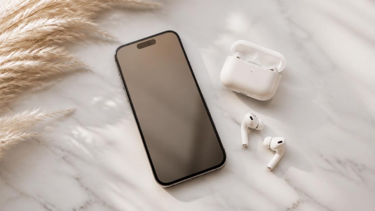 A smartphone and wireless earbuds ready to play